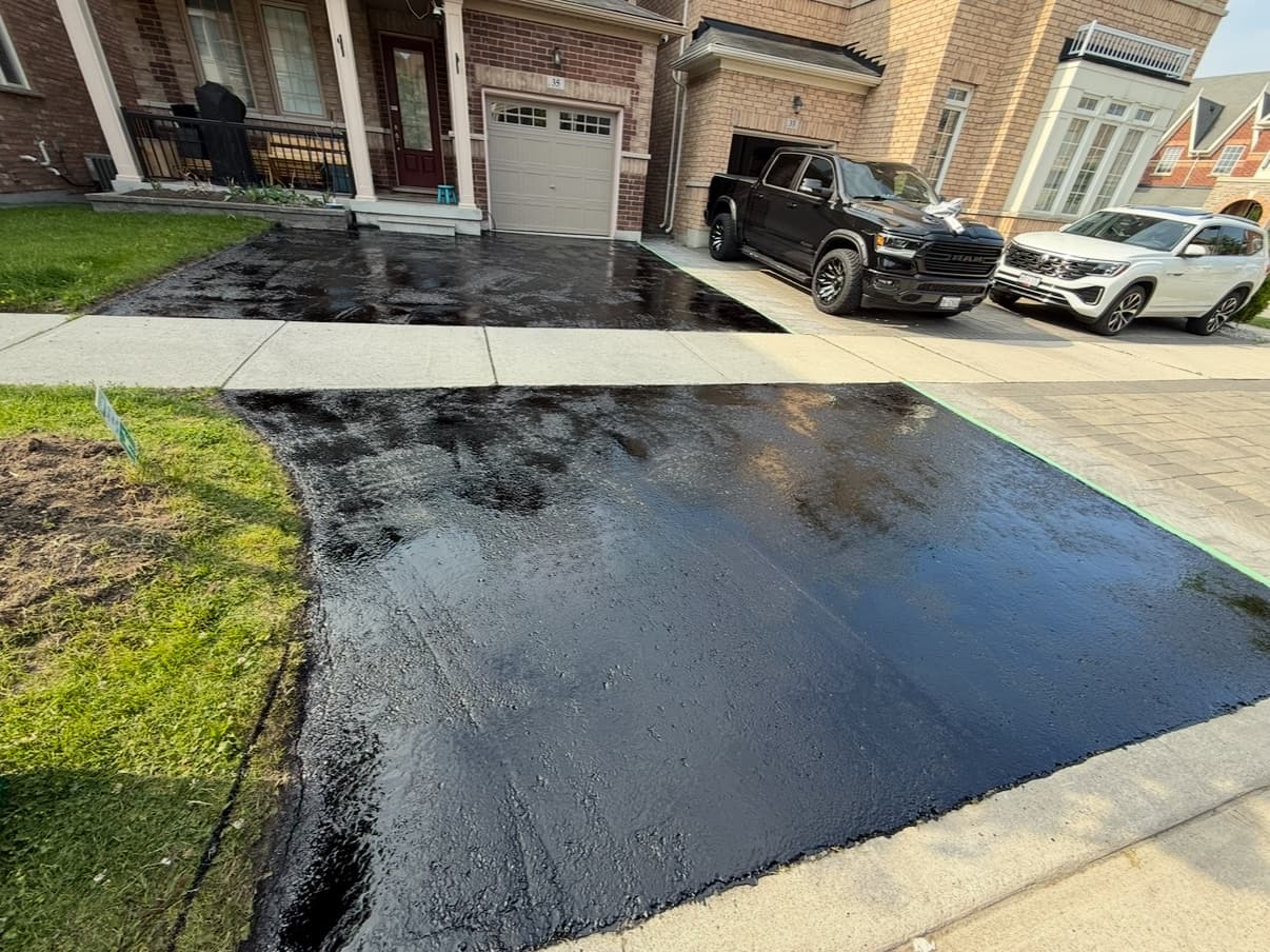 After: Driveway resealed to a glossy, jet-black finish